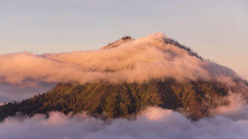 Panoramic view of volcanic mountain against sky during sunset