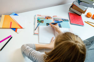 High angle view of girl doing homework