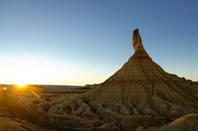 Scenic view of land against clear sky during sunset, bardenas reales, spain