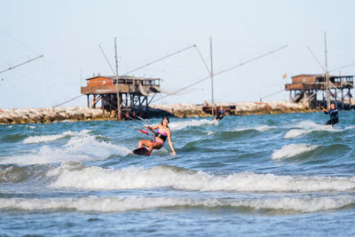 Man kayaking in sea against clear sky