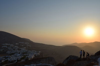 Rear view of man on mountain during sunset