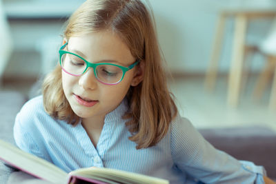 Close-up of girl reading book