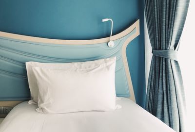 Empty chair on bed at home