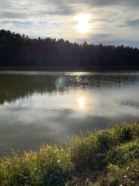 Scenic view of lake against sky during sunset