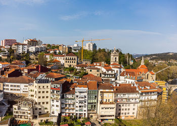 Buildings in town against sky