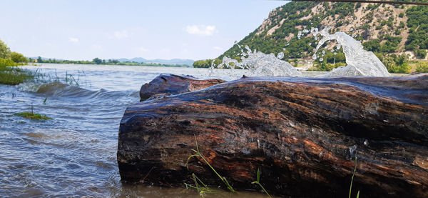 Rocks by sea against sky