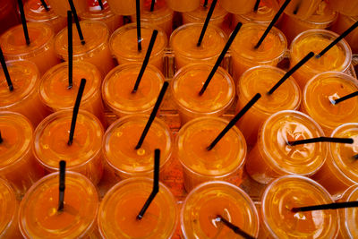 Full frame shot of orange juice in plastic cups