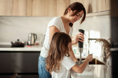 Young woman using mobile phone at home