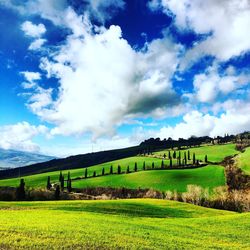 Scenic view of field against cloudy sky