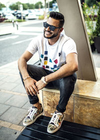 Man wearing sunglasses sitting outdoors