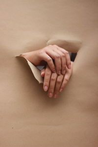 Midsection of woman lying down against gray background