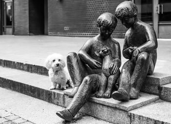 Dog sitting on statue
