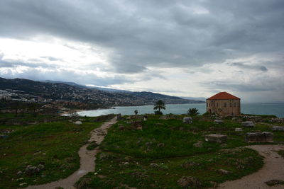 Buildings in city against cloudy sky