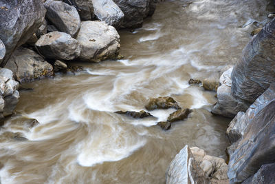 High angle view of water flowing through rocks