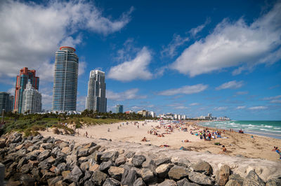 Panoramic view of beach and buildings against sky