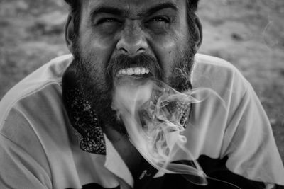 Portrait of man emitting smoke