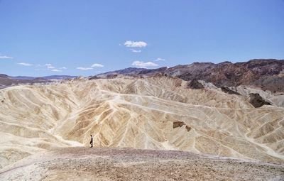 Mid distance view of man standing on mountain