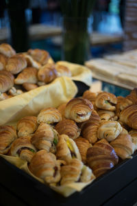 Fresh croissants in basket at restaurant