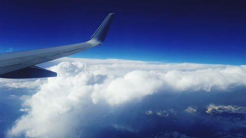 Aerial view of cloudscape over airplane wing