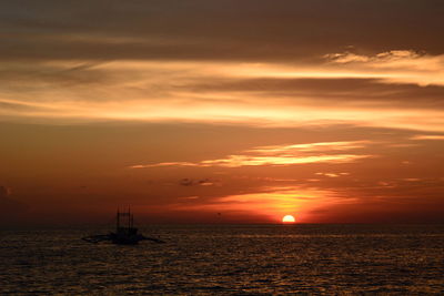 Scenic view of sea against orange sky