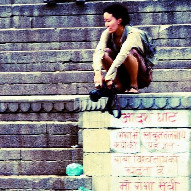 YOUNG MAN LOOKING AWAY AGAINST WALL