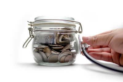 Close-up of hand holding glass jar