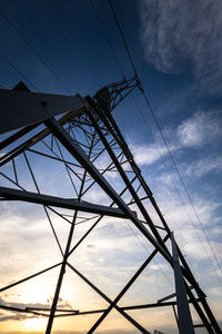 Low angle view of electricity pylon against sky