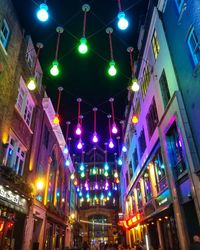 Low angle view of illuminated buildings at night