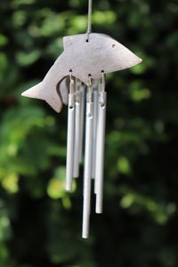 Close-up of cross hanging on wood in field