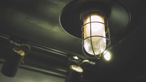 Close-up of illuminated light bulb in darkroom