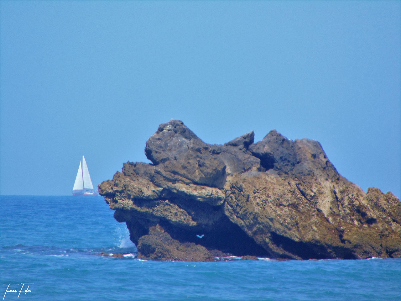 SEA AGAINST CLEAR BLUE SKY