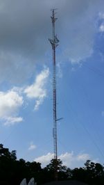 Low angle view of electricity pylon against cloudy sky