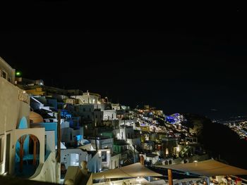 High angle view of illuminated buildings against clear sky at night