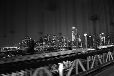 Illuminated cityscape against sky at night