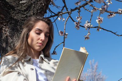 Portrait of young woman using digital tablet