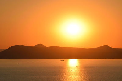 Scenic view of sea against orange sky