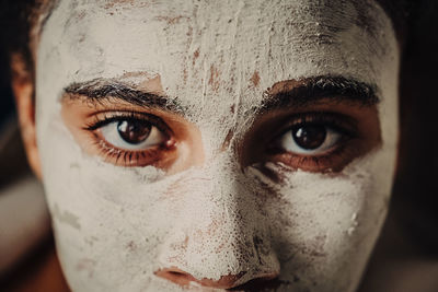 Cropped portrait of teenage girl with facial mask