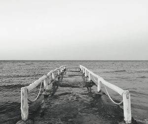 Pier over sea against clear sky