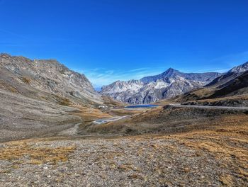 Scenic view of mountains against clear blue sky