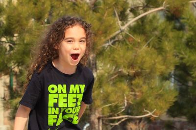 Portrait of cheerful girl screaming outdoors