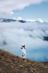 Man standing on field against sky