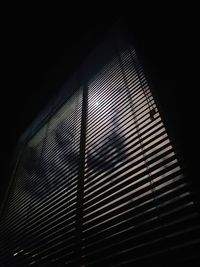 Low angle view of window blinds at night