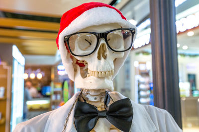 Close-up of person wearing mask and santa hat