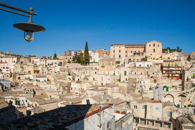 Aerial view of townscape against blue sky