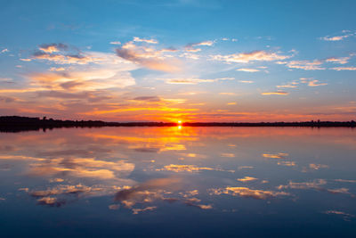 Scenic view of lake against romantic sky at sunset