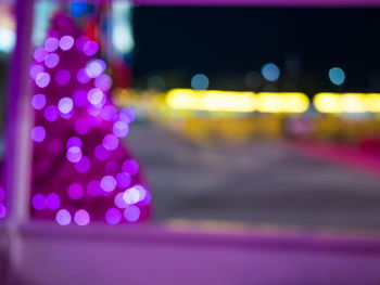 Defocused image of illuminated city at night