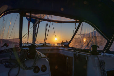 Sailboats in city against sky during sunset