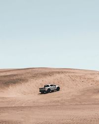 View of car on desert land