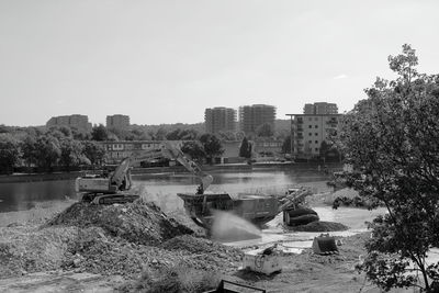 High angle view of river amidst buildings against sky