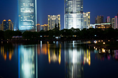 Reflection of illuminated buildings in river at night